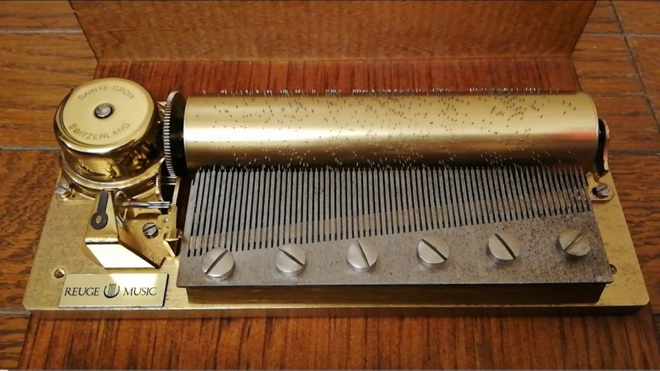 Reference photograph of an original music box with a brass cylinder and steel comb